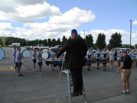 Dean Antczak directing the band from a ladder